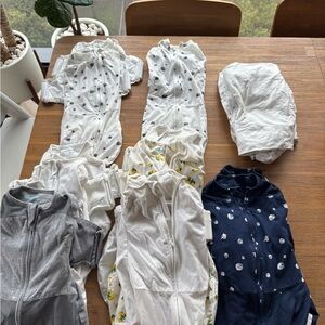Assorted Snoo Sleep Sacks and sheets